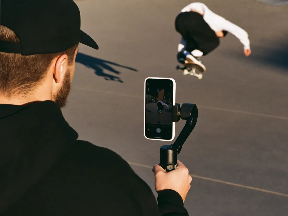 A creator filming a skater with a phone on a gimbal